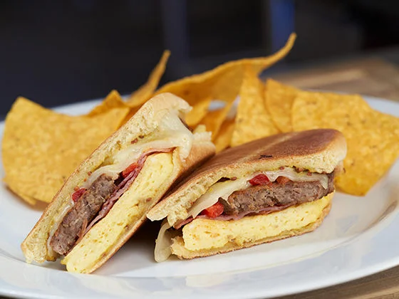 Breakfast Medianoche on a plate with chips
