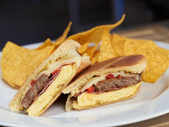 Breakfast Medianoche on a plate with chips