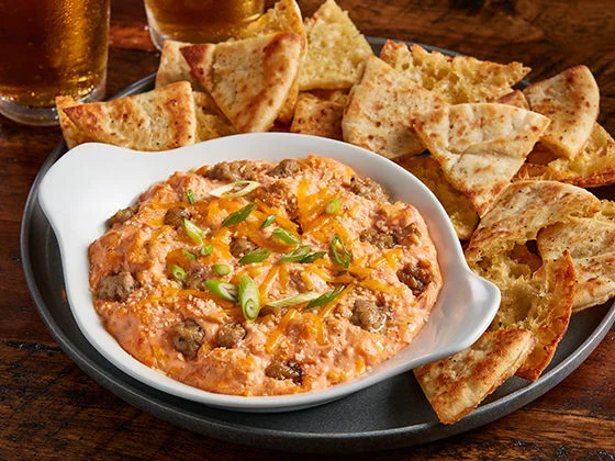 Pimento cheese and sausage dip plate with pita bread