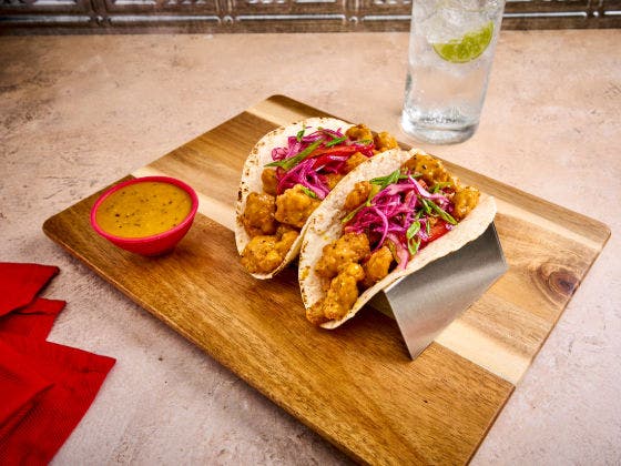 Carolina Gold BBQ Chicken Tacos on a cutting board.