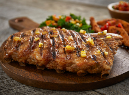 Grilled St. Louis-Style Ribs on a wooden board with sides
