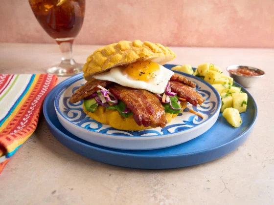 Big Concha sandwich shown on a plate with sides.