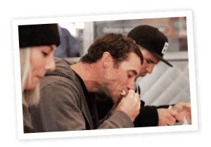 Man eating sandwich with gray hoodie