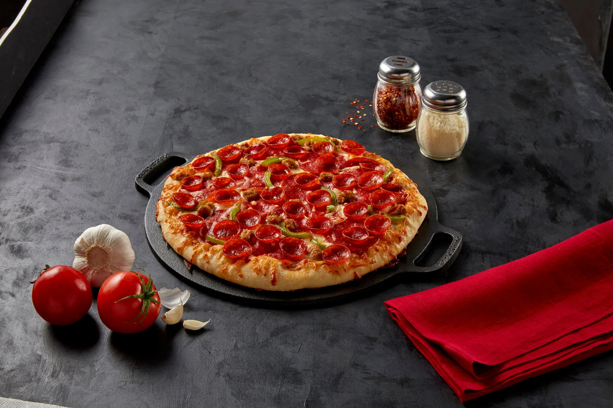 meaty trio pizza on a skillet tray