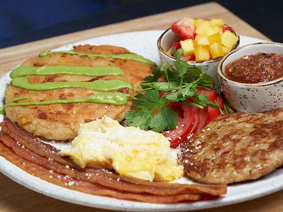 Arepa Breakfast Entree on a plate with side of salsa