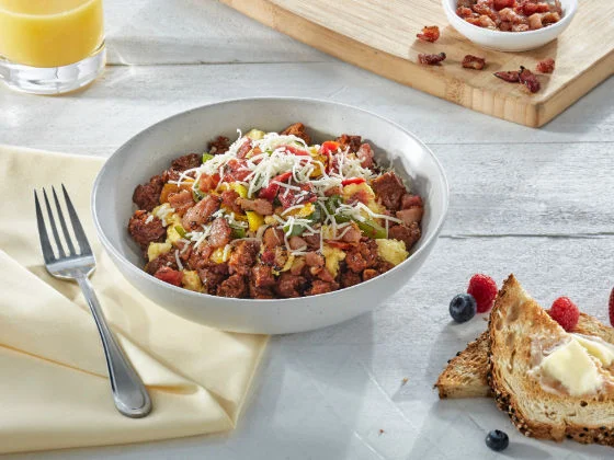 Southwest Sunrise Bowl with pork chorizo crumbles, scrambled eggs, crispy bacon, roasted peppers, tomatoes and Monterey Jack cheese