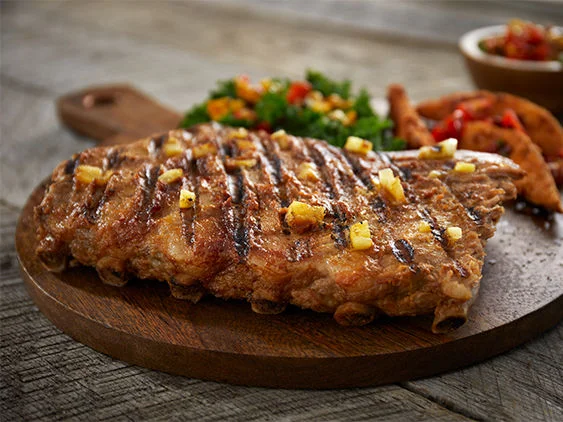 Pineapple Sriracha St. Louis-Style Ribs Recipe on a cutting board.